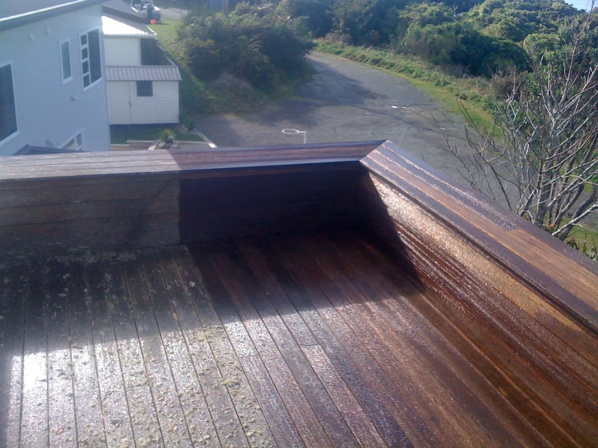 Deck restoration in Northland, before and after, weathered grey timber cleaned and restored to fresh natural tone