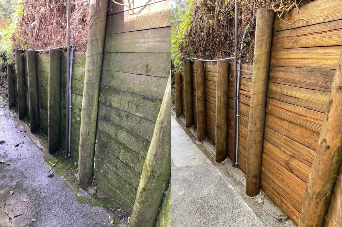 Retaining wall cleaning in Alicetown, before and after, wall blasted clean of algae and grime to restored finish